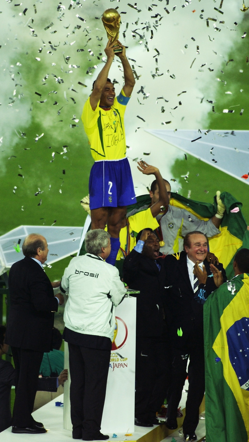 Cafu celebrates with the World Cup trophy