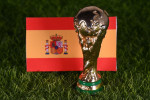 November 13, 2022, Doha, Qatar. FIFA World Cup trophy on the background of the flag of Spain on the green lawn of the stadium.
