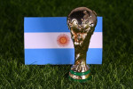 November 13, 2022, Doha, Qatar. FIFA World Cup trophy on the background of the flag of Argentina on the green lawn of the stadium.