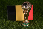 November 13, 2022, Doha, Qatar. FIFA World Cup trophy on the background of the flag of Belgium on the green lawn of the stadium.