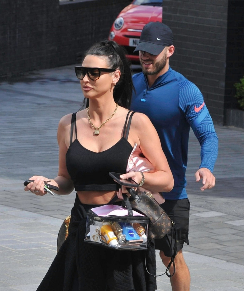 *STRICTLY NOT AVAILABLE FOR DAILY MAIL ONLINE USAGE* Glamour Model Alice Goodwin kisses new boyfriend Josh Richie as they leave the Dakota Hotel in Manchester.
