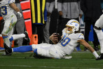 Jacksonville, USA. 14th Jan, 2023. Quarterback Justin Herbert slides for a first down as the Chargers compete against the Jaguars in the NFL Wildcard Playoff game at the TIAA Bank Field in Jacksonville, Florida on Saturday, January 14, 2023. The Jaguars d