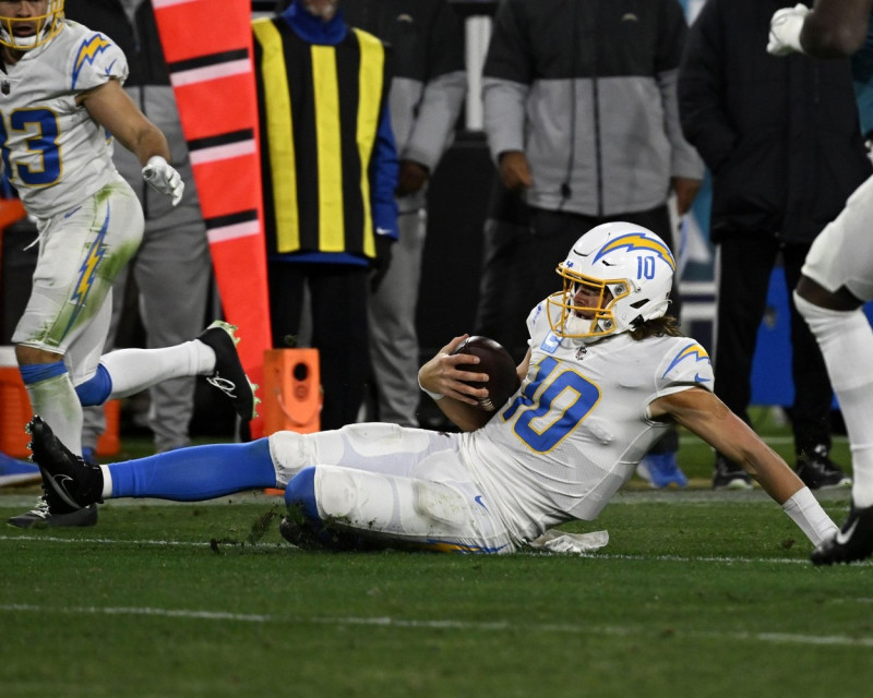 Jacksonville, USA. 14th Jan, 2023. Quarterback Justin Herbert slides for a first down as the Chargers compete against the Jaguars in the NFL Wildcard Playoff game at the TIAA Bank Field in Jacksonville, Florida on Saturday, January 14, 2023. The Jaguars d