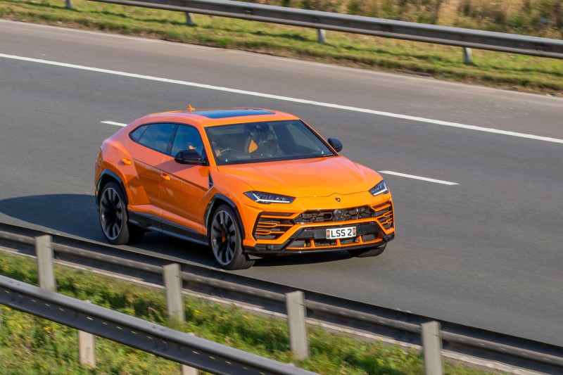 2021 Orange LAMBORGHINI URUS V8 Auto 3996vv Petrol 8 speed automatic roadster, a high-end superfast sportscar Super Sport Utility Vehicle travelling on the M61 motorway UK