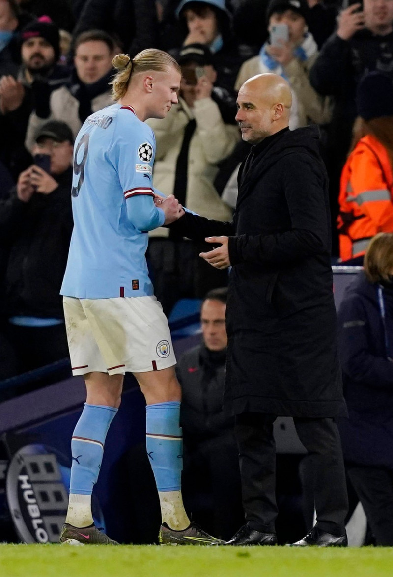 Manchester, England, 14th March 2023. Erling Haaland of Manchester City hugs Josep Guardiola manager of Manchester City