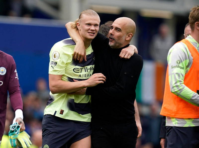 Liverpool, England, 14th May 2023. Josep Guardiola manager of Manchester City (r) hugs Erling Haaland of Manchester City