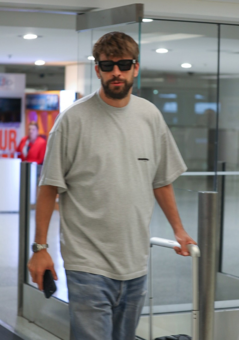 *EXCLUSIVE* Gerard Pique is ambushed by media as he arrives at Miami International Airport