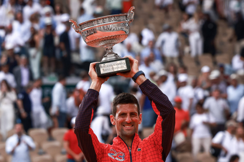 Serbia s Novak Djokovic raises the trophy Des Mousquetaires following his victory against Norway s Casper Ruud during th