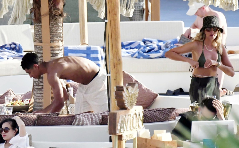 *EXCLUSIVE* WEB MUST CALL FOR PRICING - English footballer Jude Bellingham who is heavily linked with a move to Real Madrid is pictured chatting to some ladies while enjoying his summer vacation at SantAnna Beach Club in Mykonos.