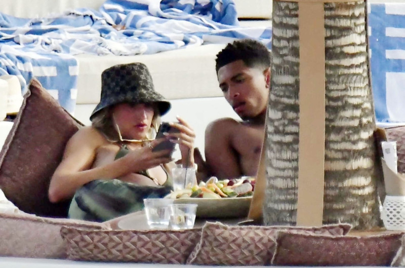 *EXCLUSIVE* WEB MUST CALL FOR PRICING - English footballer Jude Bellingham who is heavily linked with a move to Real Madrid is pictured chatting to some ladies while enjoying his summer vacation at SantAnna Beach Club in Mykonos.