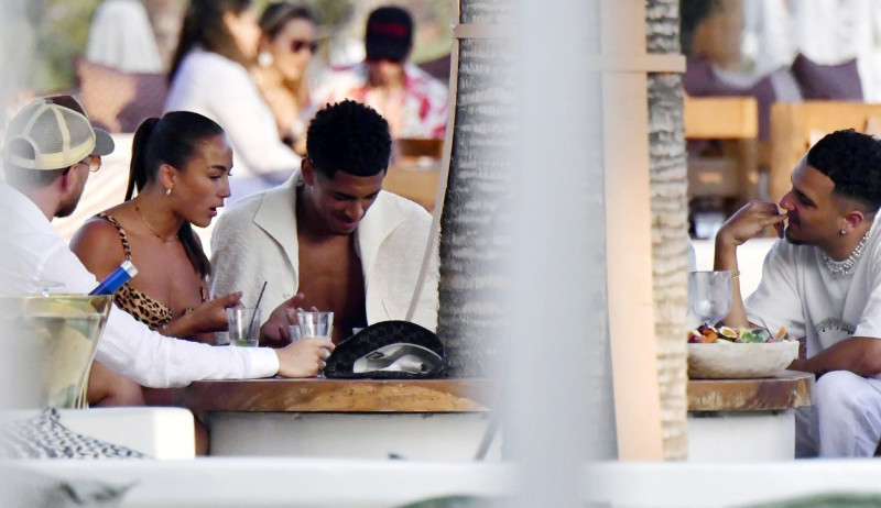 *EXCLUSIVE* WEB MUST CALL FOR PRICING - English footballer Jude Bellingham who is heavily linked with a move to Real Madrid is pictured chatting to some ladies while enjoying his summer vacation at SantAnna Beach Club in Mykonos.