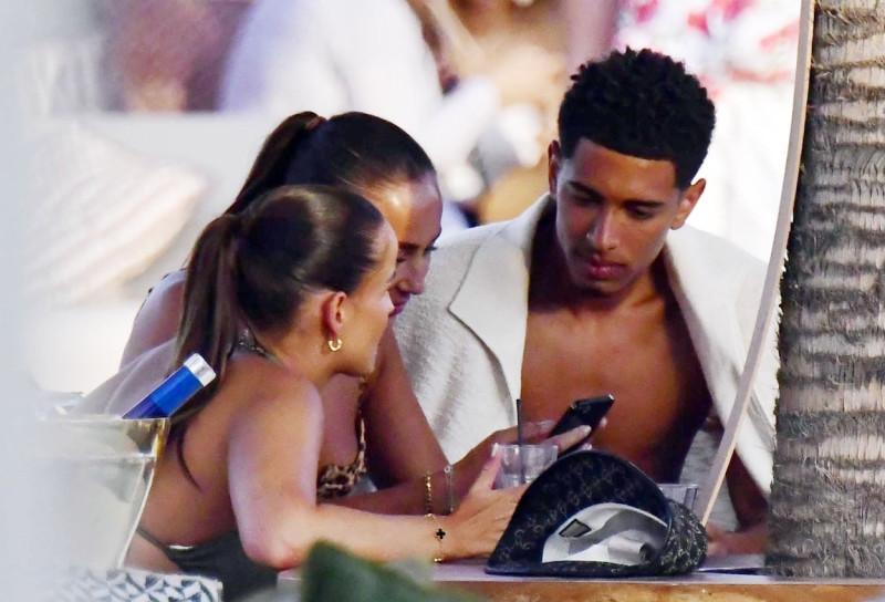 *EXCLUSIVE* WEB MUST CALL FOR PRICING - English footballer Jude Bellingham who is heavily linked with a move to Real Madrid is pictured chatting to some ladies while enjoying his summer vacation at SantAnna Beach Club in Mykonos.