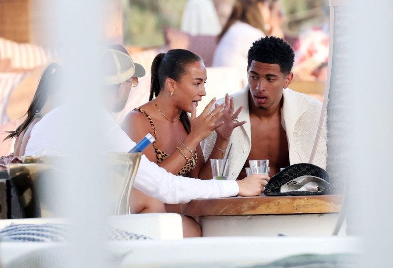 *EXCLUSIVE* WEB MUST CALL FOR PRICING - English footballer Jude Bellingham who is heavily linked with a move to Real Madrid is pictured chatting to some ladies while enjoying his summer vacation at SantAnna Beach Club in Mykonos.