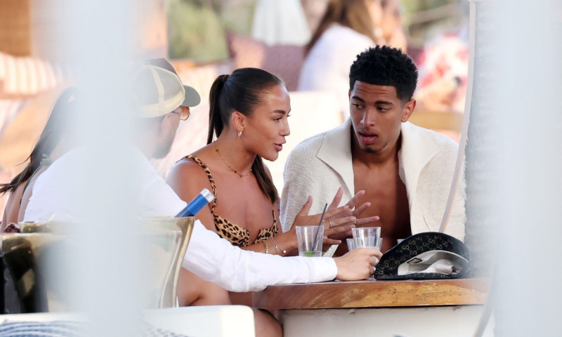 *EXCLUSIVE* WEB MUST CALL FOR PRICING - English footballer Jude Bellingham who is heavily linked with a move to Real Madrid is pictured chatting to some ladies while enjoying his summer vacation at SantAnna Beach Club in Mykonos.