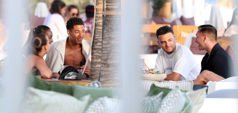 *EXCLUSIVE* WEB MUST CALL FOR PRICING - English footballer Jude Bellingham who is heavily linked with a move to Real Madrid is pictured chatting to some ladies while enjoying his summer vacation at SantAnna Beach Club in Mykonos.