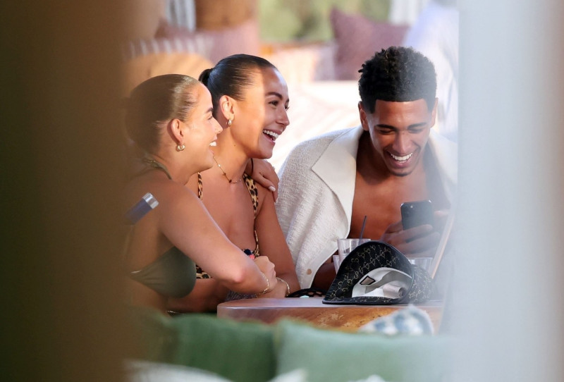 *EXCLUSIVE* WEB MUST CALL FOR PRICING - English footballer Jude Bellingham who is heavily linked with a move to Real Madrid is pictured chatting to some ladies while enjoying his summer vacation at SantAnna Beach Club in Mykonos.