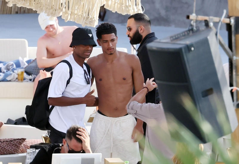 *EXCLUSIVE* WEB MUST CALL FOR PRICING - English footballer Jude Bellingham who is heavily linked with a move to Real Madrid is pictured chatting to some ladies while enjoying his summer vacation at SantAnna Beach Club in Mykonos.
