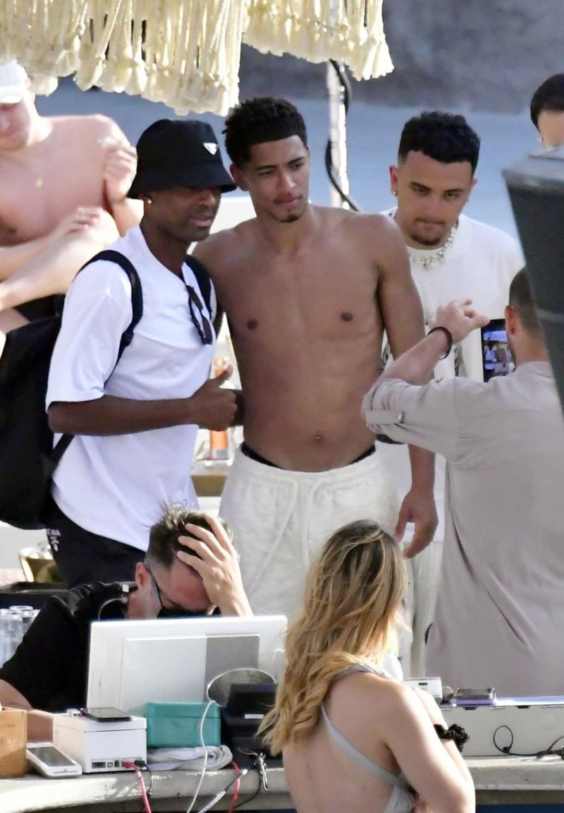 *EXCLUSIVE* WEB MUST CALL FOR PRICING - English footballer Jude Bellingham who is heavily linked with a move to Real Madrid is pictured chatting to some ladies while enjoying his summer vacation at SantAnna Beach Club in Mykonos.