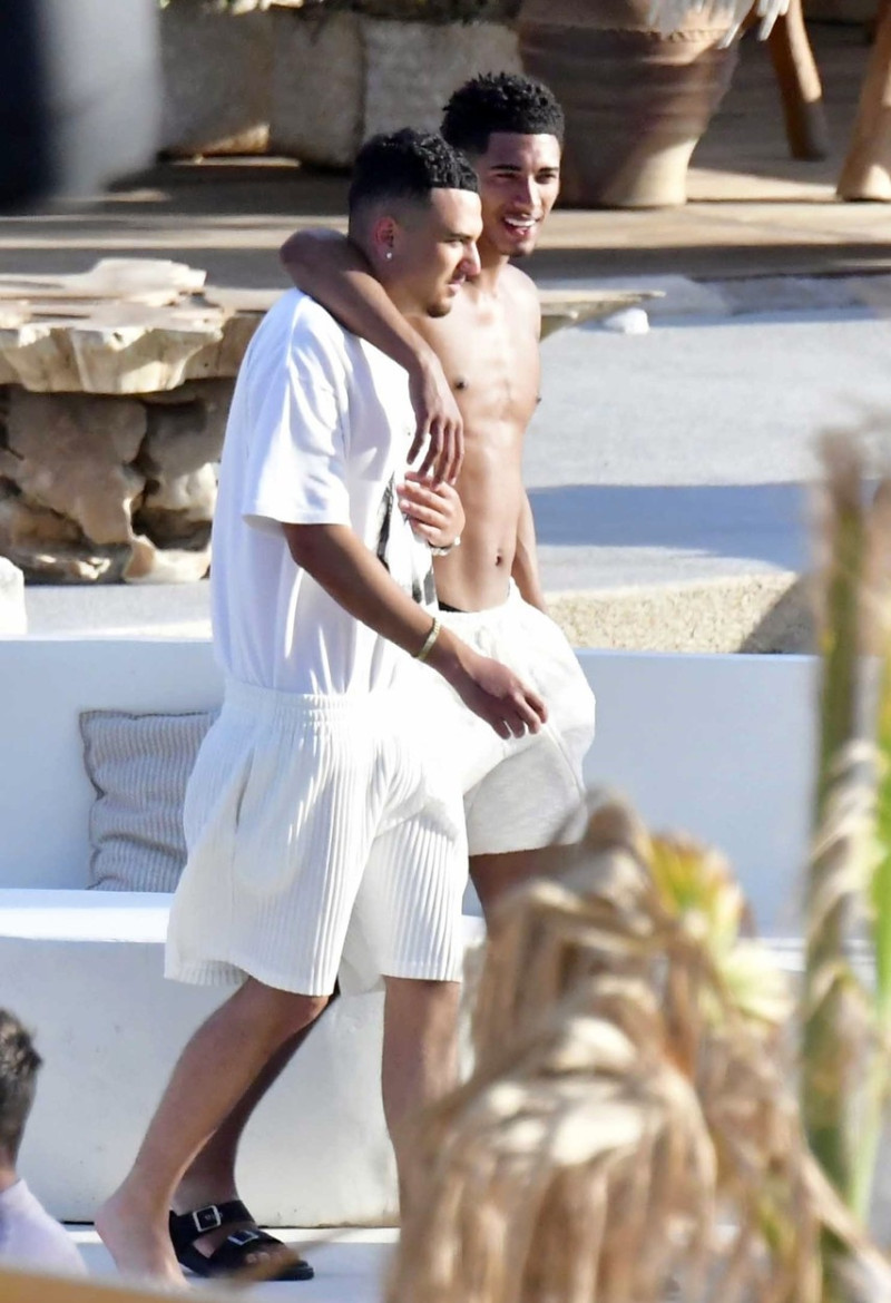 *EXCLUSIVE* WEB MUST CALL FOR PRICING - English footballer Jude Bellingham who is heavily linked with a move to Real Madrid is pictured chatting to some ladies while enjoying his summer vacation at SantAnna Beach Club in Mykonos.