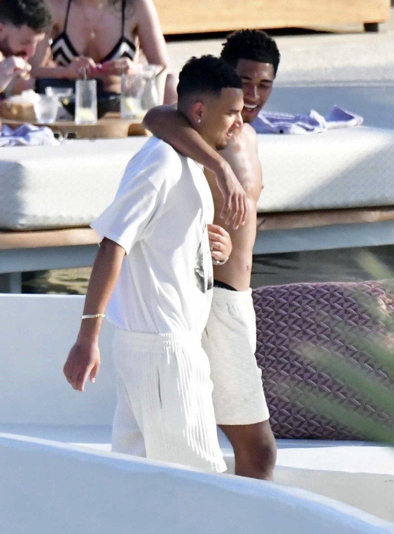 *EXCLUSIVE* WEB MUST CALL FOR PRICING - English footballer Jude Bellingham who is heavily linked with a move to Real Madrid is pictured chatting to some ladies while enjoying his summer vacation at SantAnna Beach Club in Mykonos.