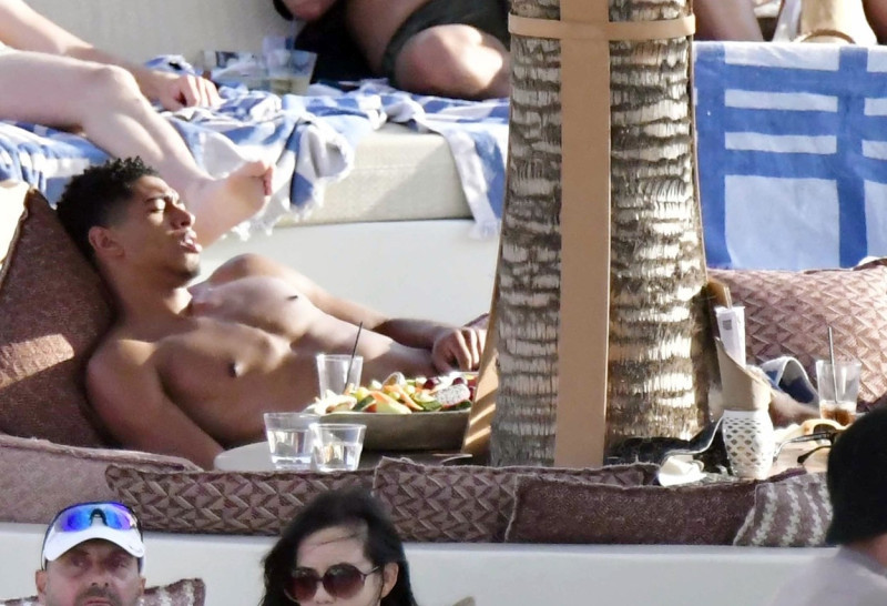 *EXCLUSIVE* WEB MUST CALL FOR PRICING - English footballer Jude Bellingham who is heavily linked with a move to Real Madrid is pictured chatting to some ladies while enjoying his summer vacation at SantAnna Beach Club in Mykonos.