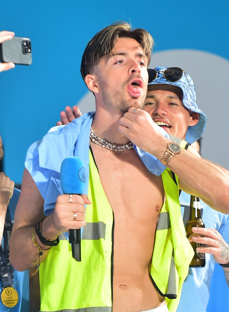 Jack Grealish ditches the Manchester City Kit for a hi vis vest at Manchester parade