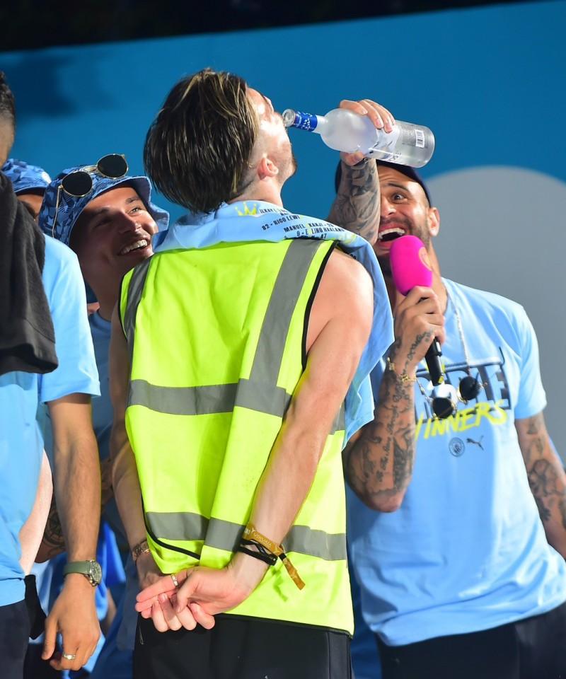 Jack Grealish ditches the Manchester City Kit for a hi vis vest at Manchester parade
