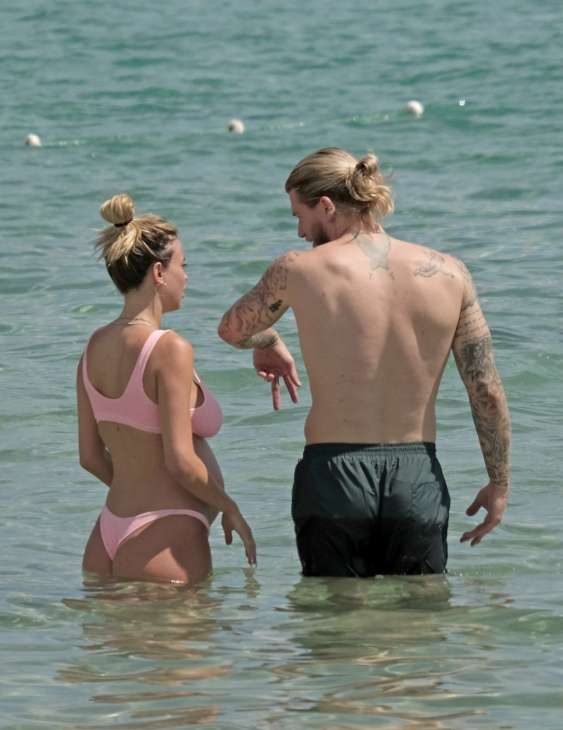 The Italian sports presenter Diletta Leotta showcases her ever-growing baby bump spotted out on the beaches of Ibiza with her beau, the Newcastle goalkeeper Loris Karius.