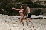 The Italian sports presenter Diletta Leotta showcases her ever-growing baby bump spotted out on the beaches of Ibiza with her beau, the Newcastle goalkeeper Loris Karius.