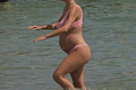 The Italian sports presenter Diletta Leotta showcases her ever-growing baby bump spotted out on the beaches of Ibiza with her beau, the Newcastle goalkeeper Loris Karius.