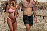 The Italian sports presenter Diletta Leotta showcases her ever-growing baby bump spotted out on the beaches of Ibiza with her beau, the Newcastle goalkeeper Loris Karius.