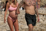 The Italian sports presenter Diletta Leotta showcases her ever-growing baby bump spotted out on the beaches of Ibiza with her beau, the Newcastle goalkeeper Loris Karius.