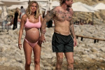 The Italian sports presenter Diletta Leotta showcases her ever-growing baby bump spotted out on the beaches of Ibiza with her beau, the Newcastle goalkeeper Loris Karius.