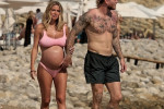 The Italian sports presenter Diletta Leotta showcases her ever-growing baby bump spotted out on the beaches of Ibiza with her beau, the Newcastle goalkeeper Loris Karius.