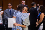 US Olympic gymnast Aly Raisman (center R) embraces McKayla Maroney after testifying during a Senate Judiciary hearing about the Inspector General's report on the FBI handling of the Larry Nassar investigation of sexual abuse of Olympic gymnasts, on Capito