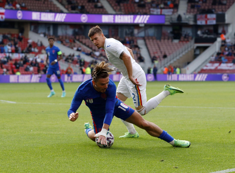 Middlesbrough, England, 6th June 2021. Jack Grealish of England brought down by Tiberiu Capusa of Romania to earn a penalty during the International Friendly match at the Riverside Stadium, Middlesbrough. Picture credit should read: Darren Staples / Sport