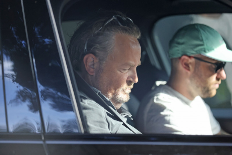 Matthew Perry, 53, is seen being driven by his assistant to a local tennis club in Los Angeles.