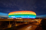 People on the Frttmaninger Mllberg on the occasion of Christopher Street Day in Munich, the Allianz Arena is illuminated in rainbow colors, which symbolize the colors of the LBGTQ movement in Munich. Bavaria, Germany, July 10, 2021. LGBTQ stands for lesb