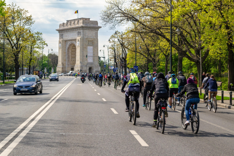 Bucharest, Romania - April 20, 2019: Cyclists marching towards "Arcul de Triumf" in protest against the lack of proper public and alternative transpor