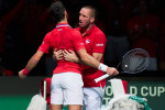 Novak Djokovic and Captain Viktor Troicki of Serbia celebrates the win over Cameron Norrie of Great Britain during the D