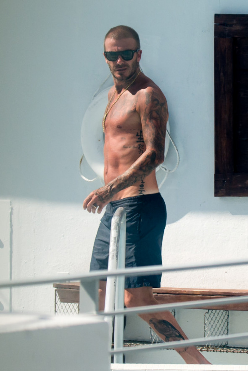 David Beckham is a Dirty Boy as he celebrates launch of football club by sunbathing and munching burgers in Miami