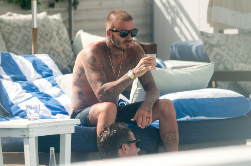 David Beckham is a Dirty Boy as he celebrates launch of football club by sunbathing and munching burgers in Miami