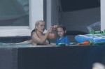 EXCLUSIVE: Christina Aguilera gets balloons and flowers as she spends Valentine's Day by the pool with her family in Miami
