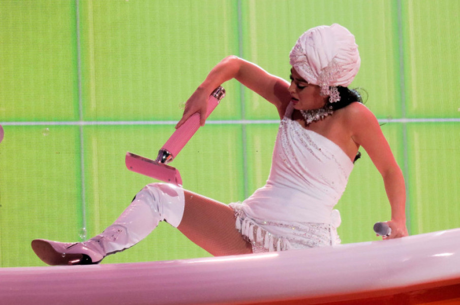 Katy Perry performs with a toilet with poop in a large bathroom set as she opens her Las Vegas Residency "Play" at the Resort World Theater in Las Vegas, NV