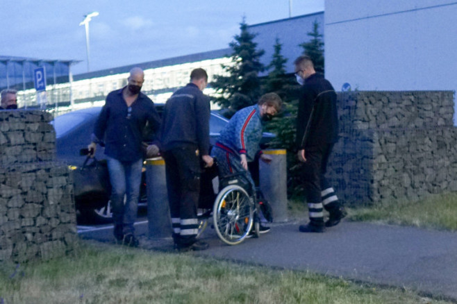 EXCLUSIVE: Elton John Arriving At Leipzig Airport In A Wheelchair After His Show In A Blue Jogging Suit