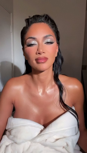 STUNNING Nicole Scherzinger thrills fans on social media by posing in a robe for a saucy video.