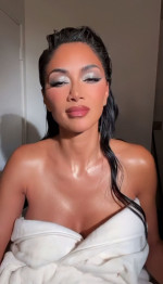 STUNNING Nicole Scherzinger thrills fans on social media by posing in a robe for a saucy video.