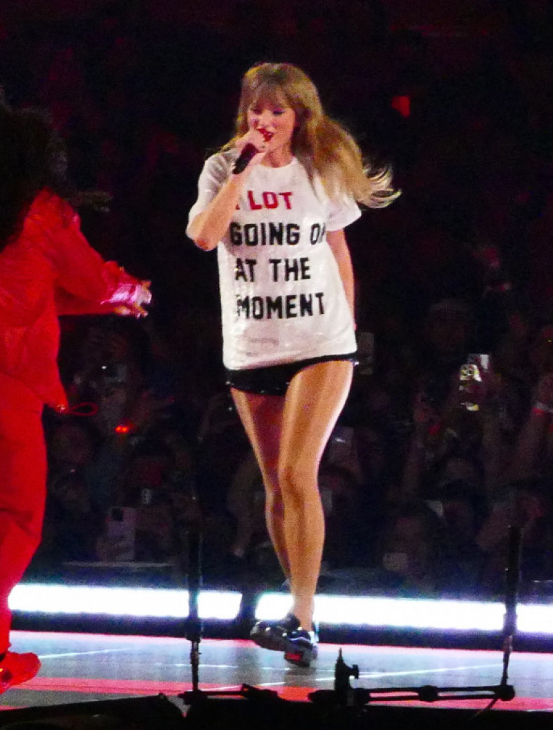 Taylor Swift wears a t shit that reads "A lot going on at the moment" as dancers help her change costume as she literally jumps on stage during 1st weekend of her massive tour in Arizona
