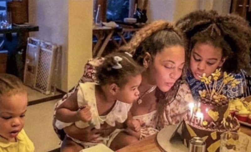 Beyonce Knowles with Blue Ivy, 11, and six-year-old twins Rumi and Sir, blowing out birthday candles