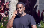 *PREMIUM-EXCLUSIVE* Sean 'Diddy' Combs appears downcast as he  relaxes by the water in Miami with  woman believed to be his longtime assisitant after settling the rape and abuse case with Cassie